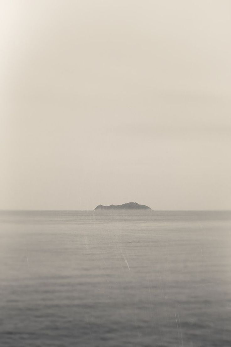 Island in the distance on a foggy day over water